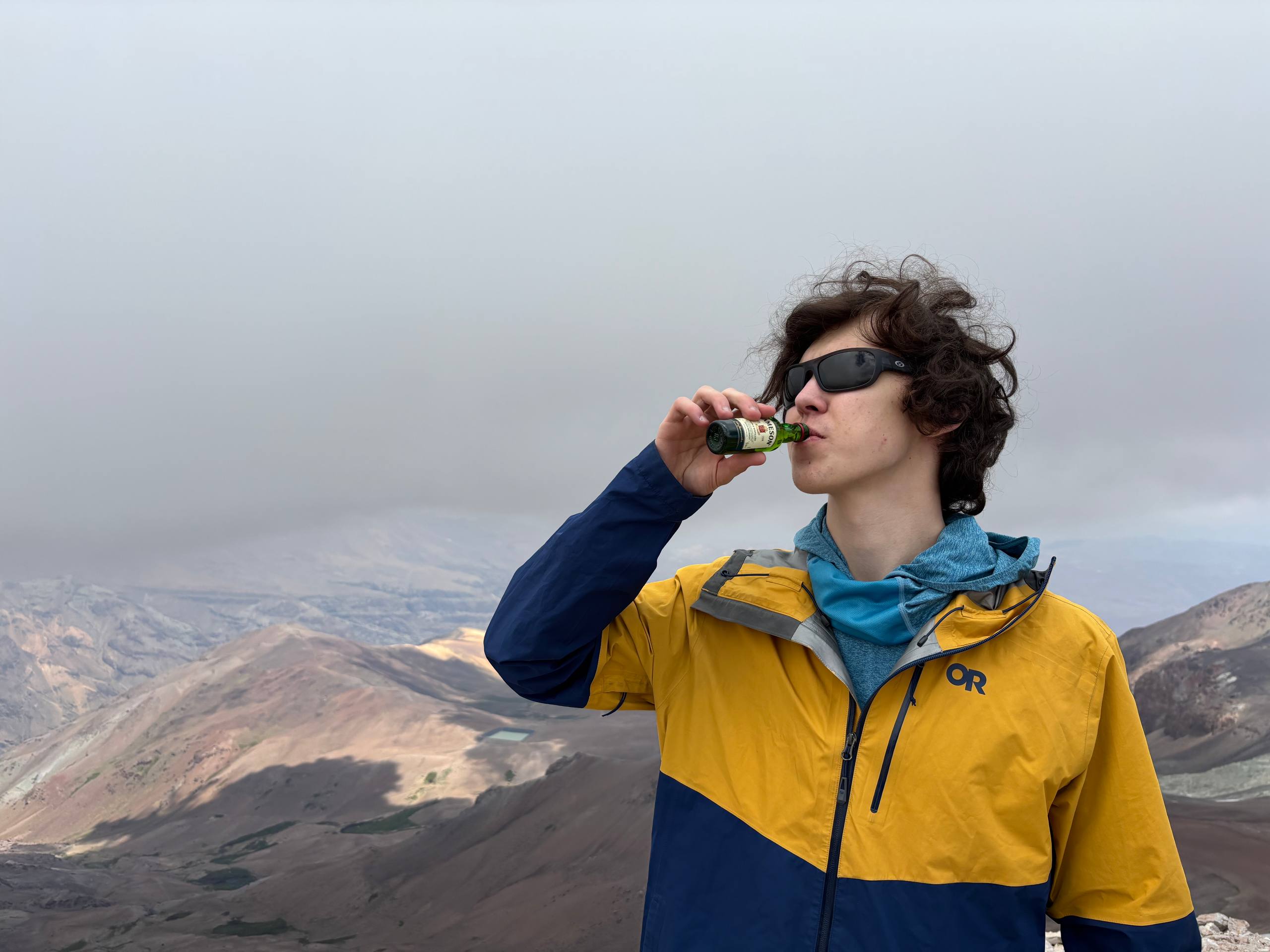 Taking a celebratory swig of whiskey at the summit to ward of altitude sickness.